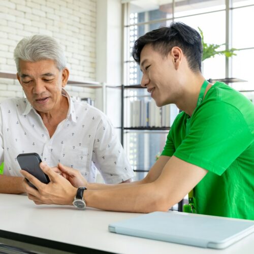 a man and a woman looking at a cell phone